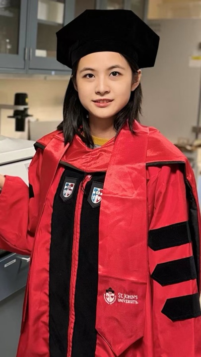 Youyou Wang in St. John's University doctoral regalia